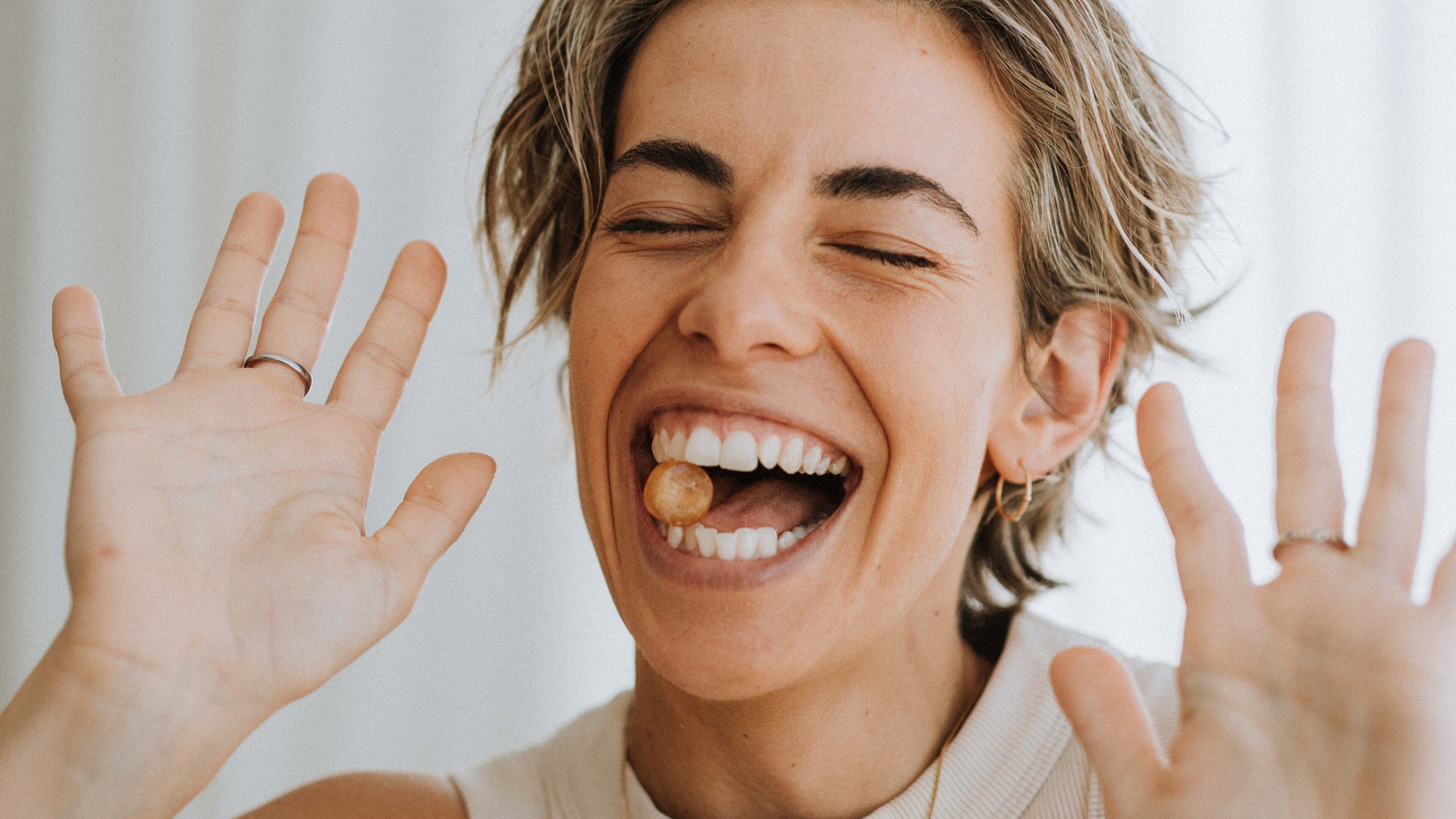 Lady with a Natural Life Propolis and Manuka Honey candy in her mouth. 